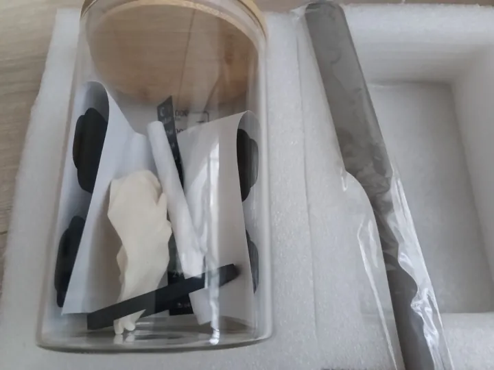Jar, wooden lid, chalk labels and spatula shown inside the opened box